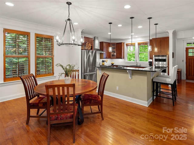 9 Dearborn St, Asheville, NC 28803 - dining space with wood-type flooring, ornamental molding, recessed lighting, a chandelier, and baseboards