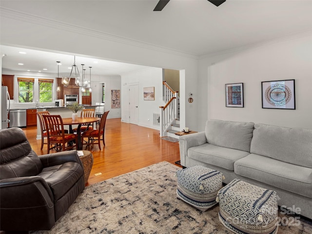 9 Dearborn St, Asheville, NC 28803 - living area featuring light wood-type flooring, ornamental molding, stairway, recessed lighting, and a ceiling fan