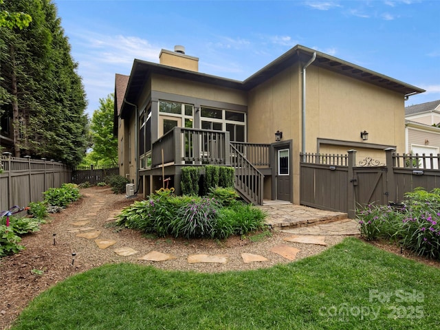 9 Dearborn St, Asheville, NC 28803 - rear view of house featuring a deck, a gate, a chimney, stairway, and stucco siding