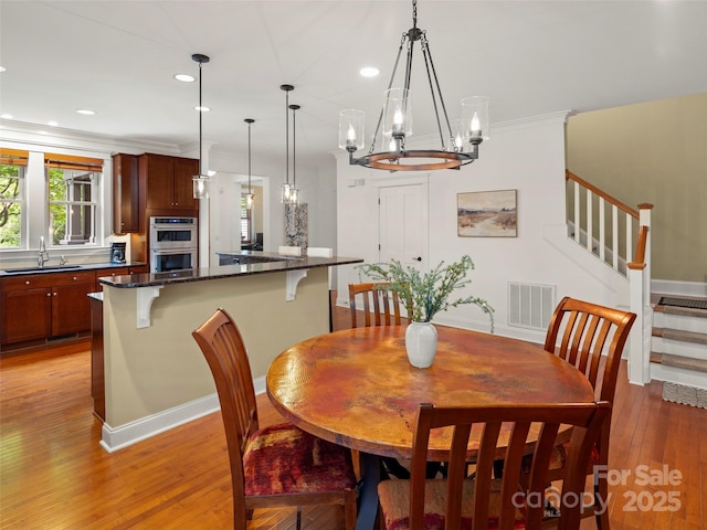9 Dearborn St, Asheville, NC 28803 - dining room featuring a chandelier, light wood-style flooring, stairs, recessed lighting, and baseboards