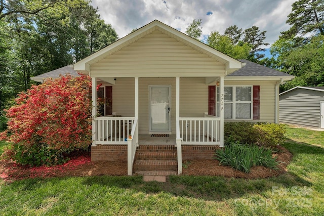 772 Austin Rd, New London, NC 28127 - bungalow with a porch, a shingled roof, and a front lawn