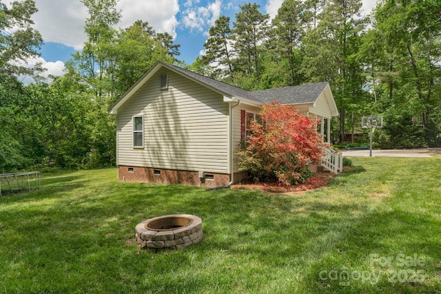 772 Austin Rd, New London, NC 28127 - view of side of home with crawl space, a fire pit, and a lawn