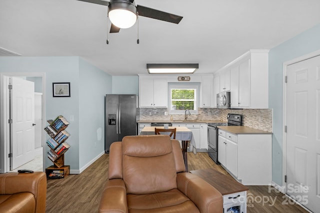 772 Austin Rd, New London, NC 28127 - kitchen with stainless steel appliances, dark wood-style floors, and decorative backsplash