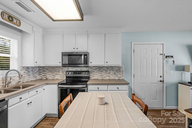 772 Austin Rd, New London, NC 28127 - kitchen with stainless steel appliances, a sink, dark wood finished floors, and backsplash