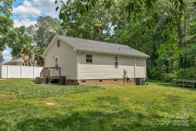 772 Austin Rd, New London, NC 28127 - back of house with a trampoline, crawl space, central air condition unit, and a shingled roof