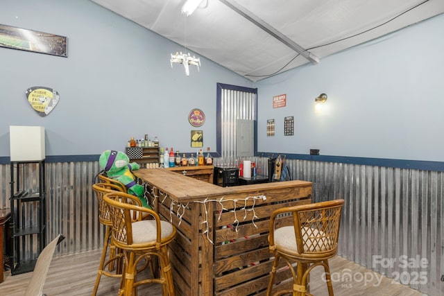 772 Austin Rd, New London, NC 28127 - indoor dry bar featuring wood finished floors, vaulted ceiling, a chandelier, and electric panel