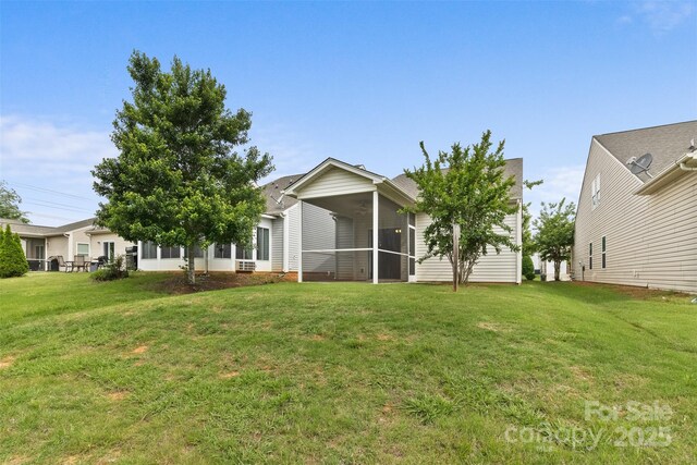5076 Newport Lakes Dr, Rock Hill, SC 29732 - back of house with a sunroom and a lawn