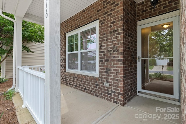 5076 Newport Lakes Dr, Rock Hill, SC 29732 - doorway to property featuring brick siding and covered porch