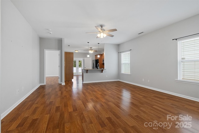 5076 Newport Lakes Dr, Rock Hill, SC 29732 - unfurnished living room with ceiling fan, healthy amount of natural light, dark wood-style flooring, and baseboards