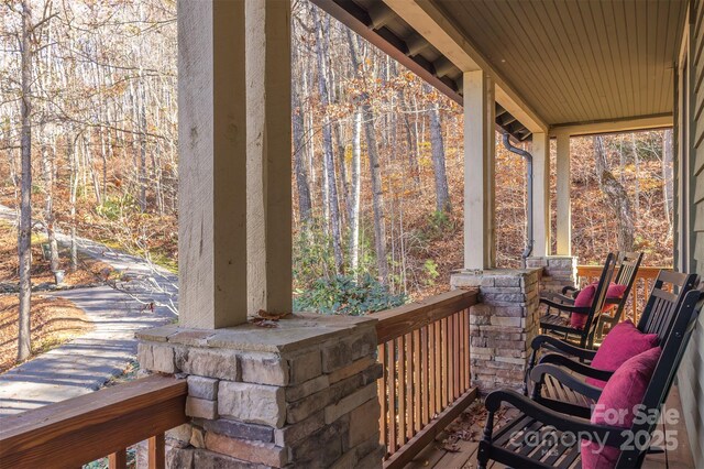 196 Juneberry Ln, Tuckasegee, NC 28783 - wooden terrace featuring a porch and a forest view