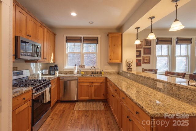 196 Juneberry Ln, Tuckasegee, NC 28783 - kitchen featuring appliances with stainless steel finishes, a sink, a peninsula, light wood-style floors, and recessed lighting