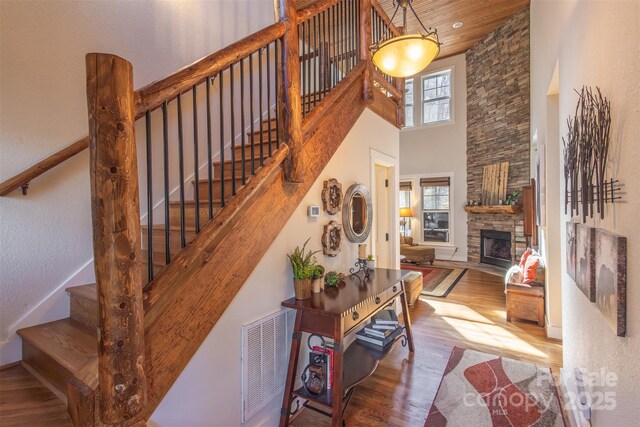 196 Juneberry Ln, Tuckasegee, NC 28783 - stairway with wood finished floors, a towering ceiling, a fireplace, and wood ceiling