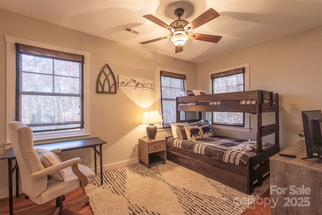 196 Juneberry Ln, Tuckasegee, NC 28783 - bedroom with baseboards, multiple windows, wood finished floors, and a ceiling fan