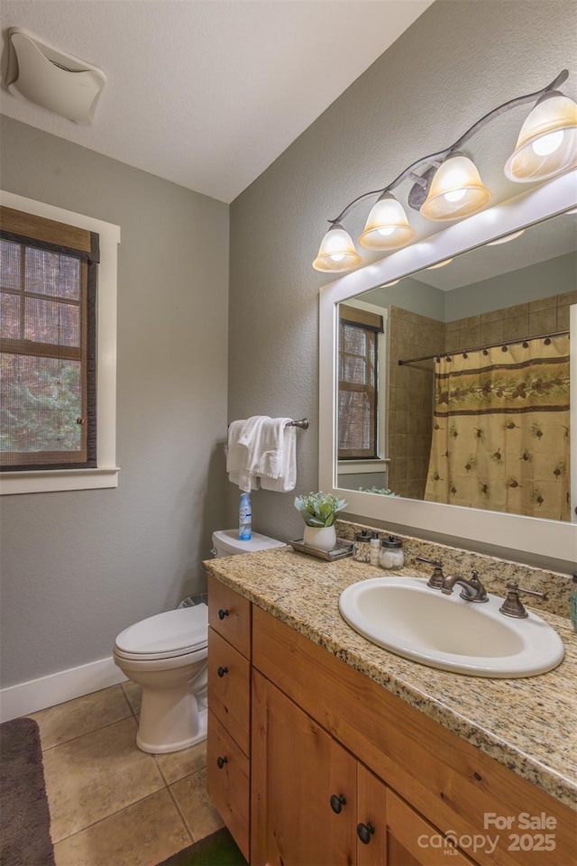 196 Juneberry Ln, Tuckasegee, NC 28783 - full bath featuring toilet, tile patterned floors, vanity, a shower with shower curtain, and baseboards
