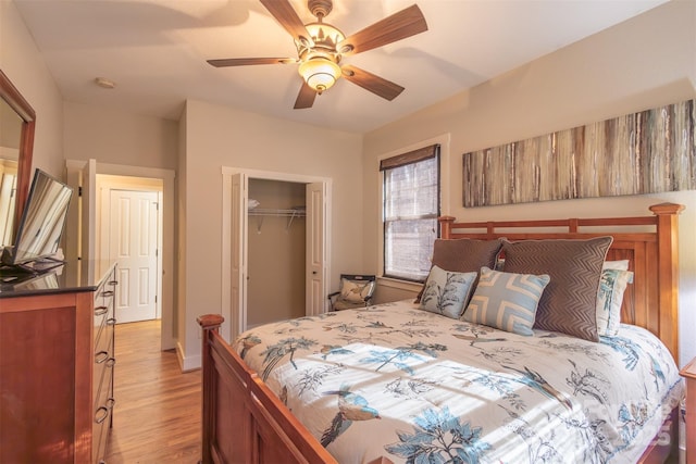 196 Juneberry Ln, Tuckasegee, NC 28783 - bedroom with light wood-style flooring, a closet, and ceiling fan