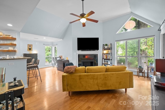 2502 Cranbrook Ln Unit 8, Charlotte, NC 28207 - living room featuring a fireplace, light wood-type flooring, ceiling fan, and high vaulted ceiling