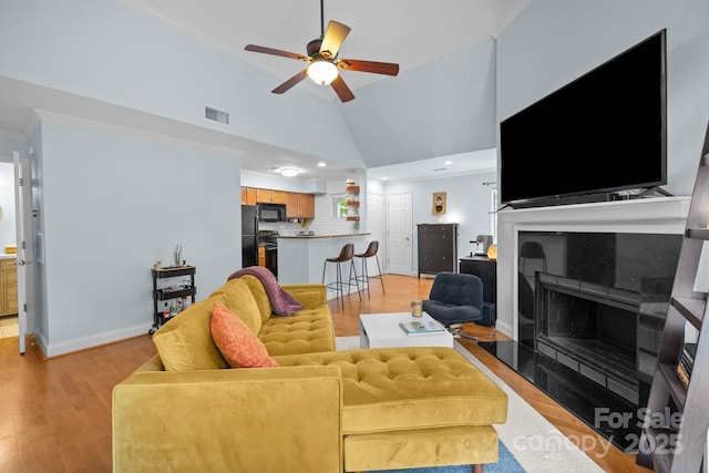 2502 Cranbrook Ln Unit 8, Charlotte, NC 28207 - living area featuring ornamental molding, ceiling fan, vaulted ceiling, light wood-style floors, and baseboards