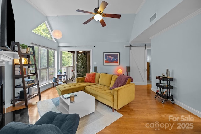 2502 Cranbrook Ln Unit 8, Charlotte, NC 28207 - living room featuring a barn door, high vaulted ceiling, ceiling fan, light wood finished floors, and baseboards