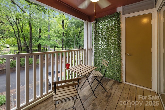 2502 Cranbrook Ln Unit 8, Charlotte, NC 28207 - wooden terrace featuring a ceiling fan and view of wooded area