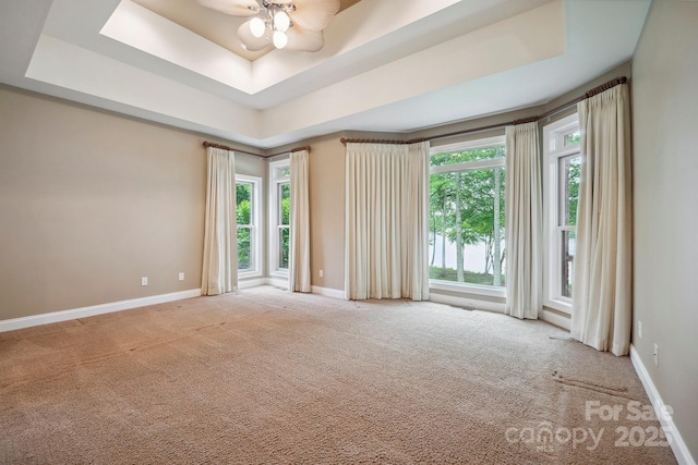 8216 Malibu Pointe Ln, Denver, NC 28037 - carpeted spare room featuring a raised ceiling, plenty of natural light, baseboards, and a ceiling fan