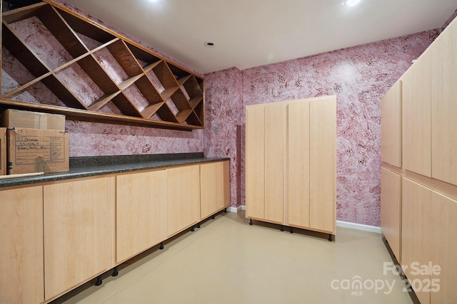 8216 Malibu Pointe Ln, Denver, NC 28037 - bar featuring wallpapered walls, baseboards, and concrete flooring