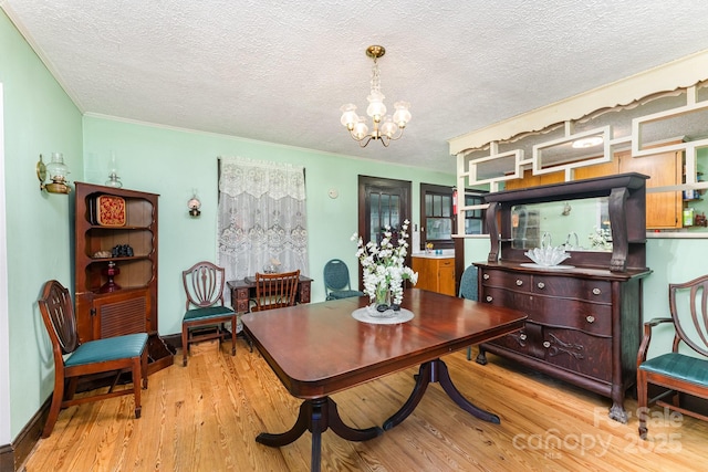 2556 Salem Church Rd, Lincolnton, NC 28092 - dining space with a chandelier, a textured ceiling, light wood-type flooring, and ornamental molding