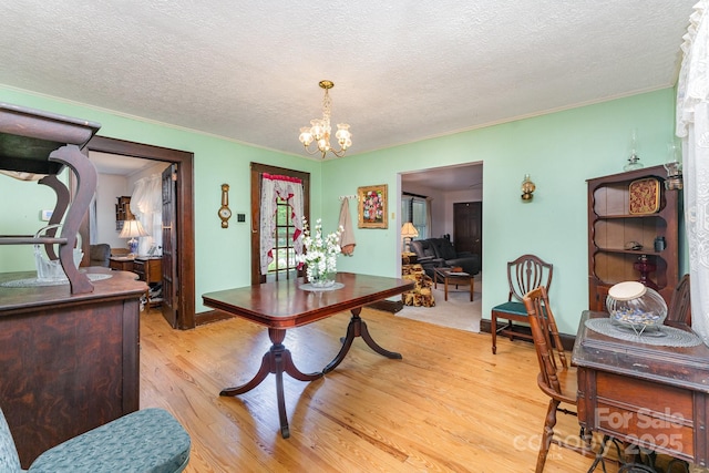 2556 Salem Church Rd, Lincolnton, NC 28092 - dining area with a textured ceiling, light wood-type flooring, a chandelier, and crown molding