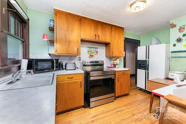 2556 Salem Church Rd, Lincolnton, NC 28092 - kitchen with electric range, white refrigerator with ice dispenser, crown molding, a sink, and black microwave