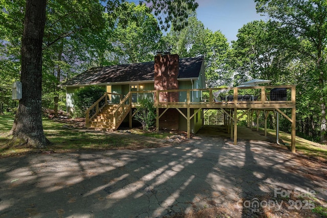 52 Reynolda Dr, Asheville, NC 28803 - back of property featuring asphalt driveway, stairs, a chimney, a carport, and a wooden deck