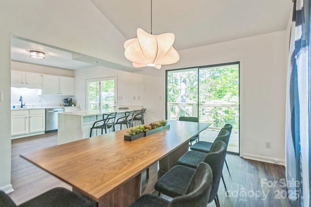 52 Reynolda Dr, Asheville, NC 28803 - dining room featuring wood finished floors, vaulted ceiling, and baseboards