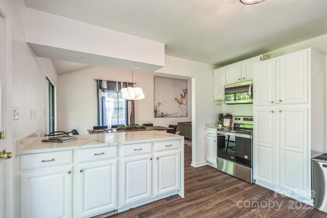 52 Reynolda Dr, Asheville, NC 28803 - kitchen featuring appliances with stainless steel finishes, dark wood finished floors, a peninsula, white cabinetry, and hanging light fixtures