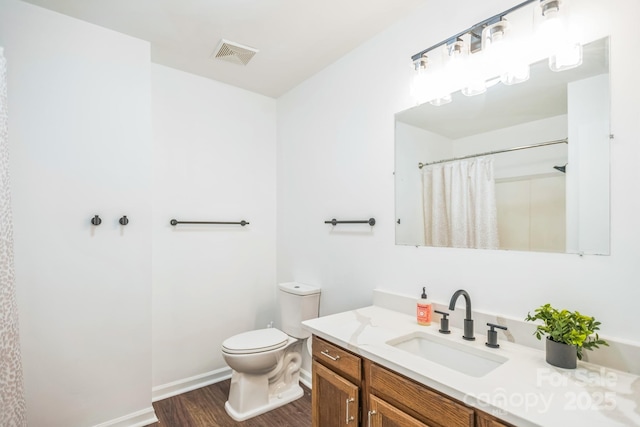 52 Reynolda Dr, Asheville, NC 28803 - bathroom featuring wood finished floors, toilet, vanity, baseboards, and a shower with shower curtain
