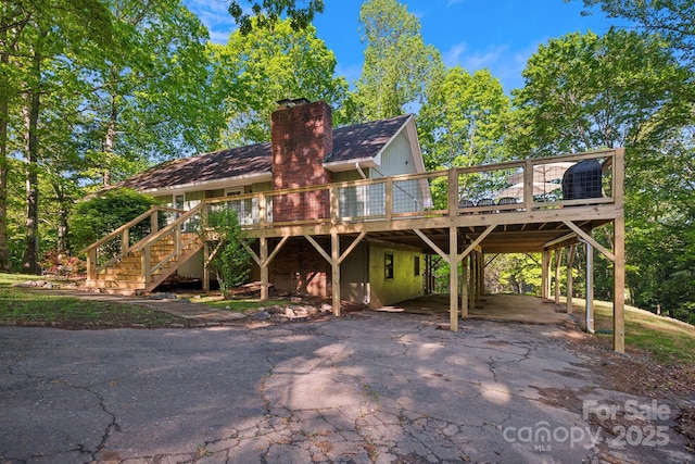 52 Reynolda Dr, Asheville, NC 28803 - back of house with a deck, asphalt driveway, stairway, and a chimney