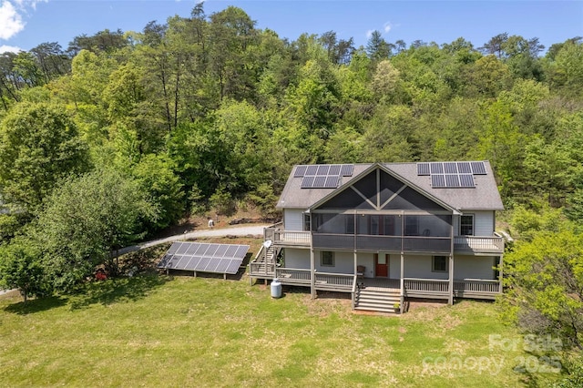 980 S River Rd, Sylva, NC 28779 - back of property with ground mounted solar panels, a view of trees, and a lawn