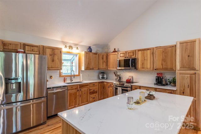 980 S River Rd, Sylva, NC 28779 - kitchen featuring appliances with stainless steel finishes, a sink, lofted ceiling, tasteful backsplash, and light wood-type flooring