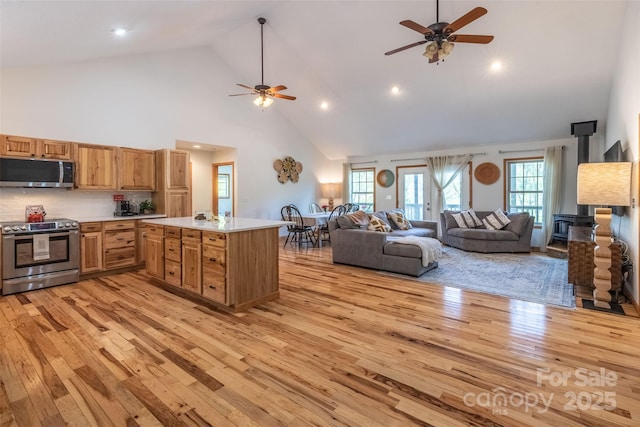 980 S River Rd, Sylva, NC 28779 - kitchen featuring stainless steel appliances, ceiling fan, high vaulted ceiling, light wood-style floors, and open floor plan
