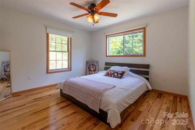 980 S River Rd, Sylva, NC 28779 - bedroom featuring multiple windows, light wood finished floors, baseboards, and ceiling fan