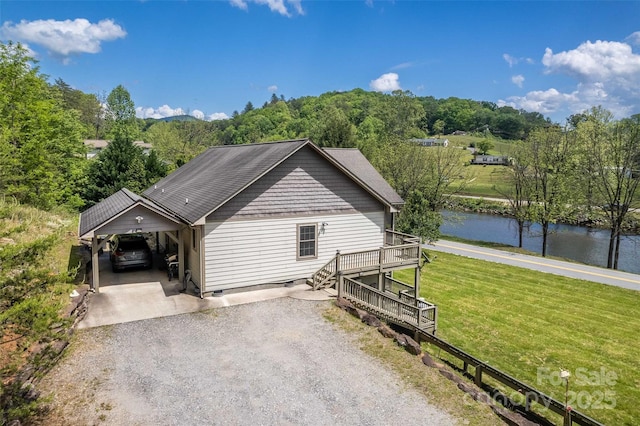 980 S River Rd, Sylva, NC 28779 - view of front of house with a front lawn, a water view, gravel driveway, a carport, and crawl space