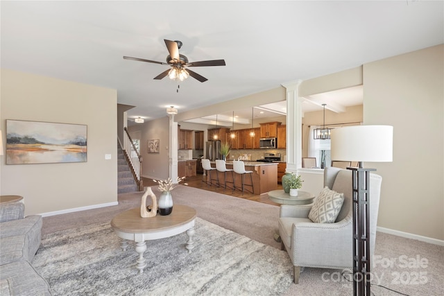 3211 Gilroy Dr, Fort Mill, SC 29707 - living room featuring a ceiling fan, baseboards, stairs, and decorative columns