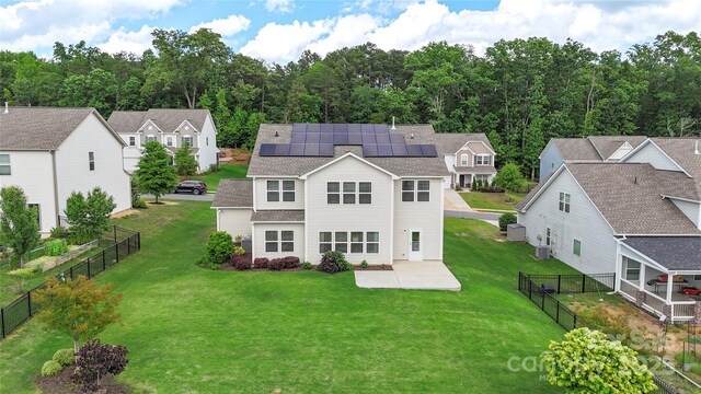 3211 Gilroy Dr, Fort Mill, SC 29707 - back of house featuring roof mounted solar panels, a patio area, a residential view, and a shingled roof