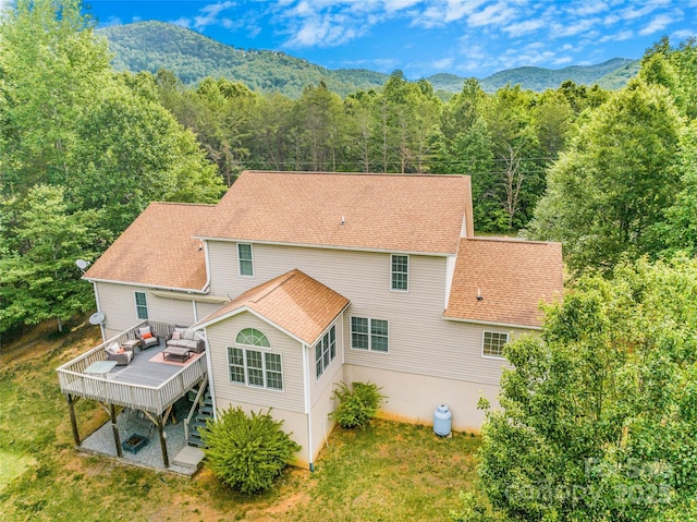 121 W Ashe Bridge Rd W, Marion, NC 28752 - back of property with a deck with mountain view, a wooded view, roof with shingles, and stairs
