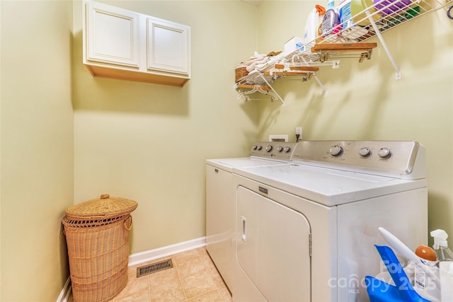 121 W Ashe Bridge Rd W, Marion, NC 28752 - laundry room with washing machine and dryer, cabinet space, baseboards, and light tile patterned flooring