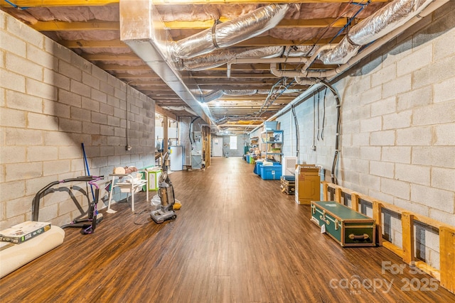 121 W Ashe Bridge Rd W, Marion, NC 28752 - below grade area featuring gas water heater, wood finished floors, heating unit, and concrete block wall