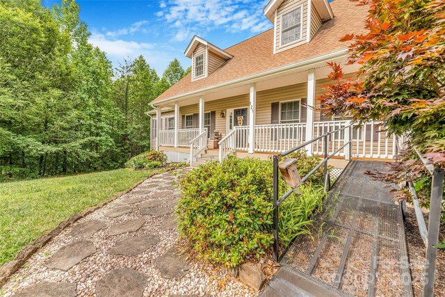 121 W Ashe Bridge Rd W, Marion, NC 28752 - cape cod-style house with covered porch, a shingled roof, and a front yard