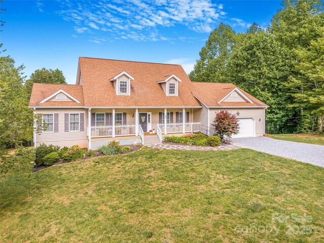 121 W Ashe Bridge Rd W, Marion, NC 28752 - cape cod-style house featuring covered porch, gravel driveway, a garage, and a front yard