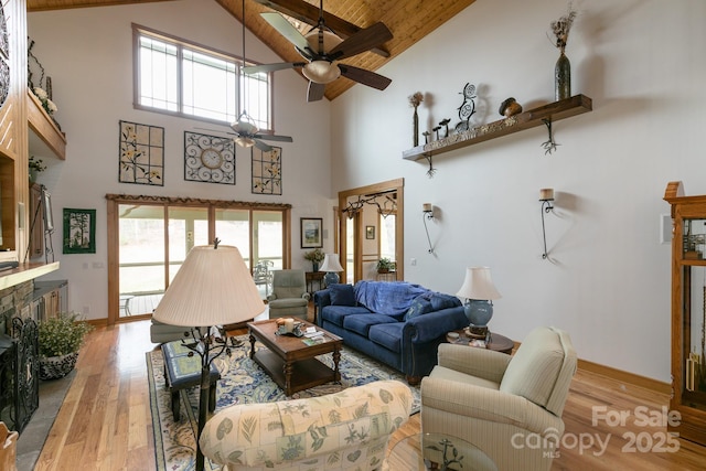 324 Austin Mountain Dr, Burnsville, NC 28714 - living area featuring high vaulted ceiling, a ceiling fan, light wood finished floors, healthy amount of natural light, and baseboards