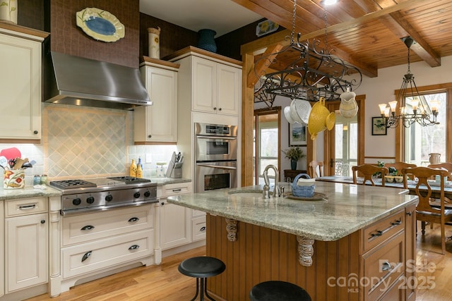 324 Austin Mountain Dr, Burnsville, NC 28714 - kitchen featuring appliances with stainless steel finishes, a chandelier, light wood-type flooring, healthy amount of natural light, and beamed ceiling