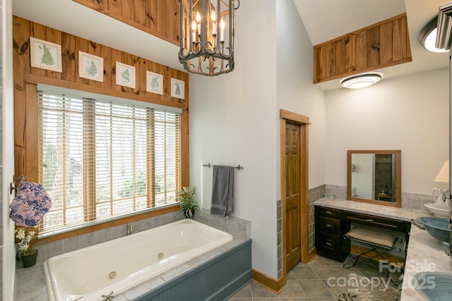 324 Austin Mountain Dr, Burnsville, NC 28714 - full bathroom featuring a jetted tub, tile patterned floors, a high ceiling, a chandelier, and vanity