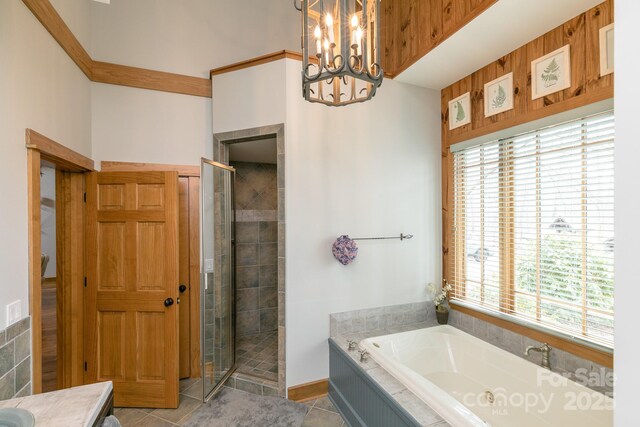 324 Austin Mountain Dr, Burnsville, NC 28714 - bathroom with a shower stall, a garden tub, a chandelier, and tile patterned flooring