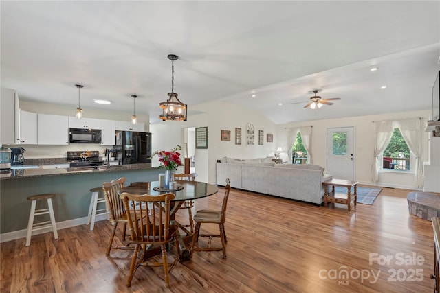 4916 Ritchie Rd, Lincolnton, NC 28092 - dining space with wood finished floors, a ceiling fan, recessed lighting, and lofted ceiling